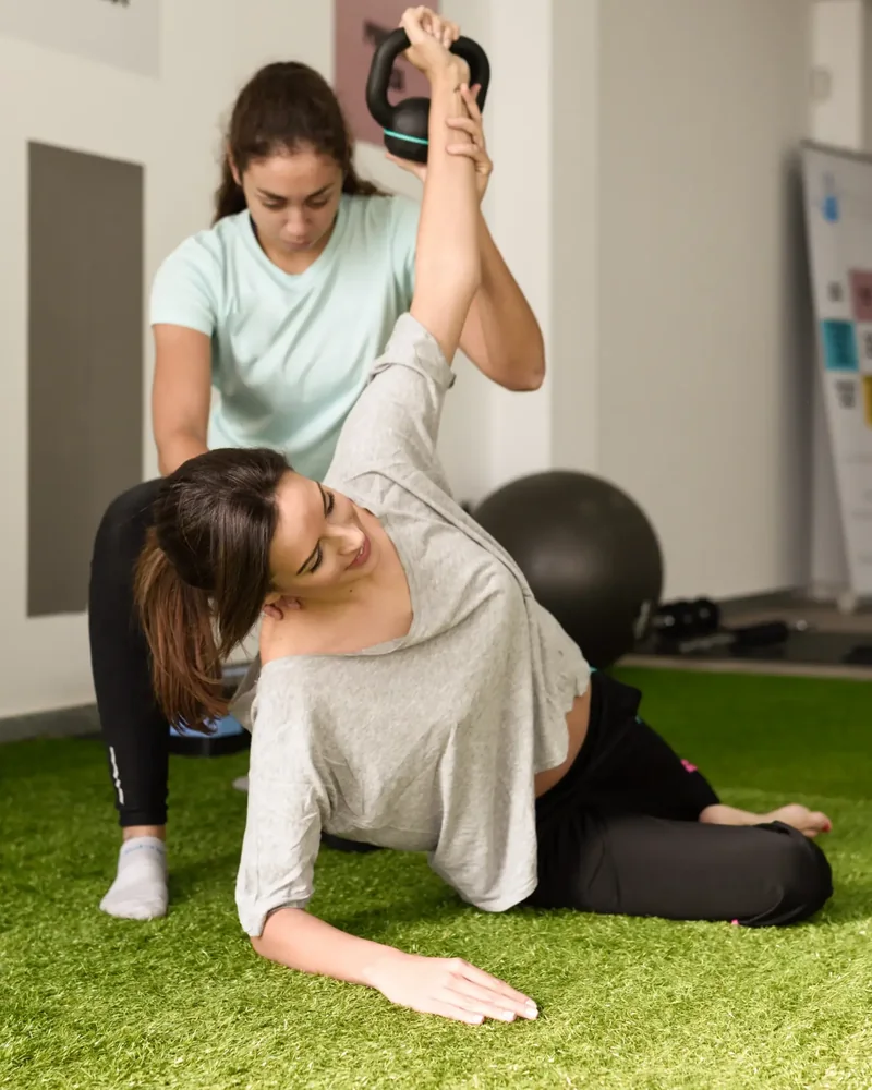 Therapist guiding a patient through an assisted thoracic stretch