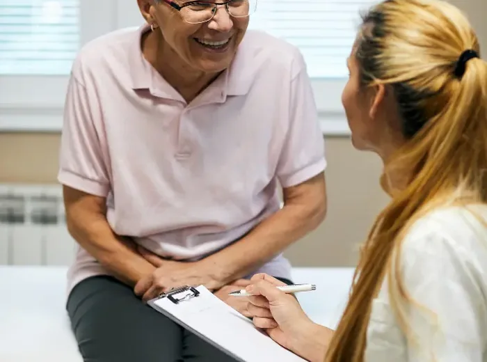 Clinician taking notes during a patient consultation